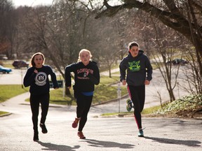 Melanie Clayton, left, Camryn Steckle and Sophie Gareau of the London Legion Track and Field Club take advantage of Monday’s weather to sprint up the hill at Gibbons Park, jog back down and repeat the process several times. (MIKE HENSEN, The London Free Press)