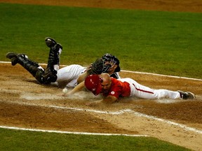 American catcher Thomas Murphy drops the ball as Canada’s Peter Orr scores the winning run in the 10th inning of their gold-medal game at the Pan Am Games in Ajax this past summer. (AFP/PHOTO)
