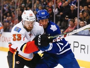 Brooks Laich of the Toronto Maple Leafs tangles with Jakub Nakladal of the Calgary Flames during a game at the Air Canada Centre at the Air Canada Centre in Toronto March 21, 2016. (Stan Behal/Toronto Sun/Postmedia Network)