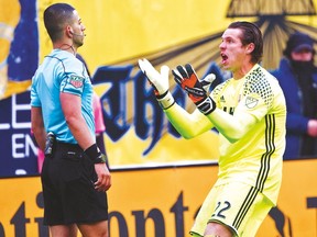New England Revolution goalkeeper Bobby Shuttleworth (right) argues a call with referee Nima Saghafi in a March MLS match.(USA TODAY)