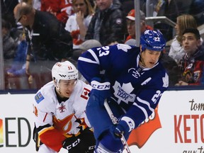Brooks Laich of the Maple Leafs skates past Mikael Backlund of the Calgary Flames on March 21, 2016, at the Air Canada Centre in Toronto. (STAN BEHAL/Toronto Sun)
