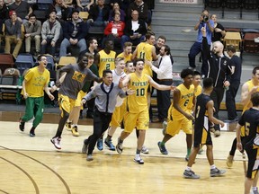 Top-seeded John Taylor Pipers players rush the court after winning the provincial high school boys 4A championship final with a 84-63 victory over the third-ranked Garden City Fighting Gophers, Monday, March 21, 2016, at the University of Manitoba.
RUSTY BARTON/For the Winnipeg Sun