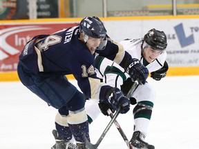 Saints' Austin Hunter and Crusaders' Ben McLeod battle for the puck during game 3 of the their best-of-seven AJHL North Division semifinal Monday at Sherwood Park.  (Greg Southam)