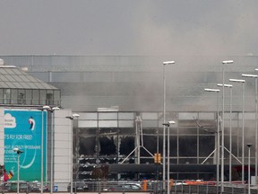 Smoke billows from the  Zaventem Airport after a controlled explosion, in Brussels, Tuesday, March 22, 2016.  (AP Photo/Michel Spingler)