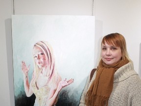 Alvinston's Liana Russwurm stands with one of her most recent works of art during the grand opening of the Wonderland exhibition at Gallery in the Grove on Mar. 13.
CARL HNATYSHYN/SARNIA THIS WEEK