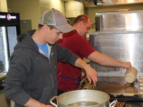 Volunteers prepare a large helping of pancakes and sausages during the 2015 Ipperwash Maple Syrup and Pancake Breakfast.
Submitted photo for SARNIA THIS WEEK