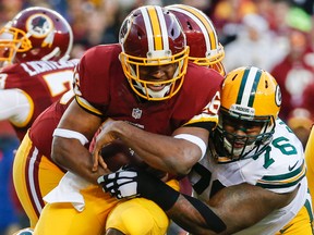 Washington Redskins running back Alfred Morris is stopped by Green Bay Packers defensive end Mike Daniels (76) during the NFL wild card playoff game in Landover, Md., Sunday, Jan. 10, 2016. (AP Photo/Alex Brandon)