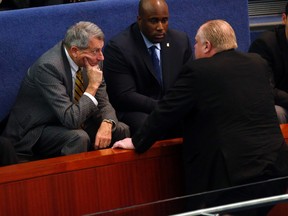 Then-mayor Rob Ford speaks with his lawyer Dennis Morris during a special city council meeting to consider the budget on Jan. 9, 2014. (Michael Peake/Toronto Sun)