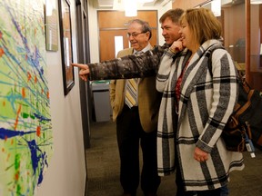 Emily Mountney-Lessard/The Intelligencer
A painting made by Thomas Martin hangs in the Belleville Public Library in Belleville. Here, his parents Robert and Charlene speak with Councillor Garnet Thompson.