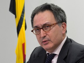 The Belgian flag is wrapped in black ribbon as Belgium Ambassador to Canada Raoul Delcorde speaks with the media during a news conference in Ottawa, Tuesday, March 22, 2016.