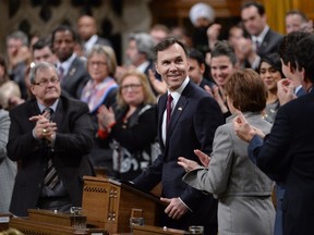 Finance Minister Bill Morneau receives applause as he tables the federal budget in the House of Commons in Ottawa on Tuesday, March 22, 2016. THE CANADIAN PRESS/Adrian Wyld
