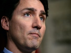 Prime Minister Justin Trudeau pauses as he responds to the deadly attacks in Brussels as he speaks in the foyer of the House of Commons on Parliament Hill in Ottawa on Tuesday, March 22, 2016. THE CANADIAN PRESS/Sean Kilpatrick