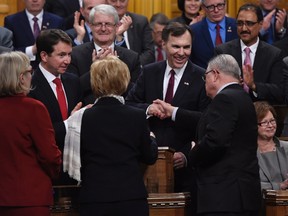 Public Safety and Emergency Preparedness Minister Ralph Goodale, right, shakes hands with Minister of Finance Bill Morneau following his federal budget speech in the House of Commons on Parliament Hill in Ottawa on Tuesday, March 22, 2016. THE CANADIAN PRESS/Adrian Wyld