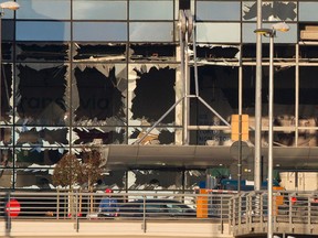 The setting sun strikes the terminal and its blown out windows at Zaventem airport, one of the sites of two deadly attacks in Brussels, Belgium, Tuesday, March 22, 2016. Authorities in Europe have tightened security at airports, on subways, at the borders and on city streets after the attacks Tuesday on the Brussels airport and its subway system.
