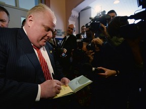 Toronto Mayor Rob Ford signs an autograph as he leaves the Big City Mayor's Meeting at Ottawa City Hall in Ottawa on Wednesday, February 26, 2014.SEAN KILPATRICK/ THE CANADIAN PRESS