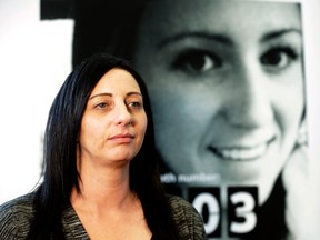 Sherrie Dolk in front of a poster of her 19-year-old daughter that is part of a campaign at Humber College to educate people on the drug fentanyl on Tuesday, March 22, 2016. Dolk lost her daughter to a fentanyl overdose. (Craig Robertson/Toronto Sun)