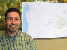 Rob Sterling, administration coordinator for the 2018 International Plowing Match & Rural Expo, stands next to a map of Chatham-Kent that depicts the area adjacent to Pain Court where the event will take place.