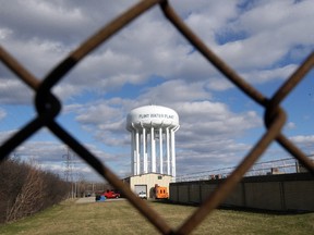 This March 21, 2016 file photo shows the Flint Water Plant water tower in Flint, Mich. A task force appointed by Gov. Rick Snyder released a report March 23, 2016 saying failures and delays within all levels of government, particularly in his administration, led residents to be "needlessly and tragically" exposed to Flint's lead-contaminated water crisis because of decisions made by its environmental regulators and state-appointed emergency managers. (AP Photo/Carlos Osorio)