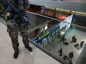 A French soldier patrols inside the Charles de Gaulle International Airport in Roissy, near Paris, France, March 23, 2016 as France has decided to deploy 1,600 additional police officers to bolster security at its borders and on public transport following the bomb attacks in Brussels.  REUTERS/Philippe Wojazer