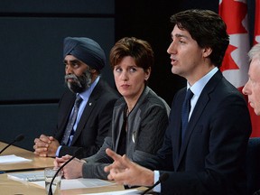 Prime Minister Justin Trudeau answers a question as he is joined by Minister of National Defence Harjit Sajjan, left to right, Minister of International Development and La Francophonie Marie-Claude Bibeau and Minister of Foreign Affairs Stephane Dion during a press conference at the National Press Theatre in Ottawa on Monday, Feb. 8, 2016. THE CANADIAN PRESS/Sean Kilpatrick