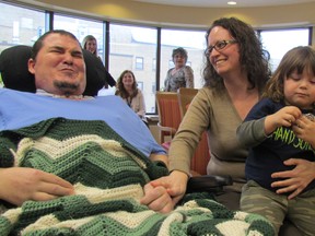 Les Shortt, Jessica McDowell, and their son Jaxon, 3, receive the keys to their accessible home from Habitat for Humanity Sarnia-Lambton on Wednesday March 23, 2016 during a ceremony at Bluewater Health in Sarnia, Ont. Shortt was injured last summer in a collision while riding his motorcycle. The Habitat home on Maria Street became available when the family it was built for moved away from Sarnia. (Paul Morden/Sarnia Observer/Postmedia Network)