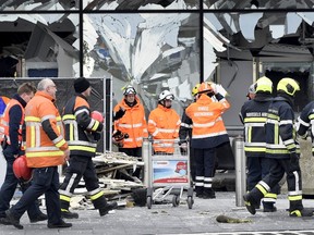 Broken windows of the terminal at Brussels national airport are seen during a ceremony following bomb attacks in Brussels metro and Belgium's National airport of Zaventem, Belgium, March 23, 2016. REUTERS/Yorick Jansens/Pool