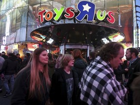 People walk past Toys R Us in Times Square the day after Christmas in the Manhattan borough of New York December 26, 2015. (REUTERS/Carlo Allegri)