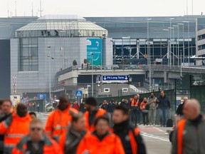 People leave the scene of explosions at Zaventem airport near Brussels, Belgium, March 22, 2016.    REUTERS/Francois Lenoir