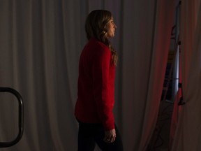 Olympian Rosie MacLennan looks around a curtain as she is introduced to the audience as the Canadian Olympic Committee launches their game plan initiative in Toronto on Sept. 24, 2015. (THE CANADIAN PRESS/Chris Young)