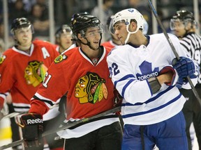 Toronto Maple Leafs forward Josh Leivo and Chicago Blackhawks forward Garret Ross exchange insults during second-period action at a rookie tournament in London, Ont., on Sept. 13, 2014. (DEREK RUTTAN/ The London Free Press)