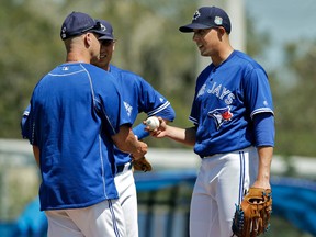 Toronto Blue Jays pitcher Aaron Sanchez hands the ball to pitching coach Pete Walker after being taken out a game against the New York Mets in Dunedin, Fla., on March 23, 2016. (AP Photo/Chris O'Meara)