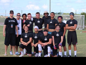 Members of the Recruit Ready crew from Winnipeg pose with Carolina Panthers quarterback Cam Newton at the national championship in Florida in 2014.