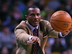 Raptors head coach Dwane Casey passes the ball back to a referee during the first quarter against the Celtics on Wednesday. (AP)