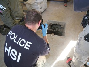 A U.S. Homeland Security Investigations (HSI) Special Response Team agent photographs the tunnel exit point during investigation of a cross-border tunnel linking Calexico, U.S. and Mexicali, Mexico in Calexico, California March 23, 2016.  REUTERS/U.S. Immigration and Customs Enforcement/Handout via Reuters