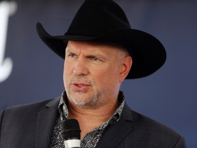 Garth Brooks is shown after receiving a star on the Music City Walk of Fame on Thursday, Sept. 10, 2015, in Nashville, Tenn. An influx of Garth Brooks fans to Hamilton is temporarily pushing some Syrian refugee families out. Various media reports say more than 200 Syrian refugees were bumped from their accommodations at downtown Hamilton hotels to make way for thousands of Brooks fans who already booked rooms. (THE CANADIAN PRESS/AP-Mark Humphrey)