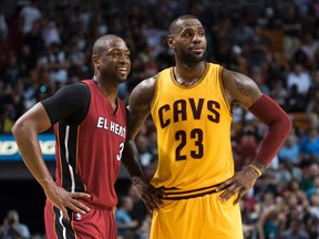 Heat guard Dwyane Wade (3) talks with Cavaliers forward LeBron James (23) during second half NBA action in Miami on March 19, 2016. (Steve Mitchell/USA TODAY Sports)