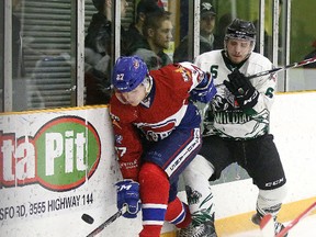 Mackenzie MacMillan of the Rayside-Balfour Canadians and Josef Kittelberger of the Elliot Lake Wildcats battle for the puck during NOJHL playoff action  in Sudbury on Wednesday.