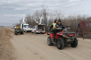 A crew of searchers on ATVs head out to look through farmers' field and ditches hoping to find 2 year old Chase Martens near Austin, Man., on Thursday, March 24, 2016. THE CANADIAN PRESS/John Woods