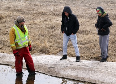 Searchers inspect a ditch on the side of Road 72, west of the Martens family house while looking for two-year-old Chase Martens on Thursday March 24, 2016. (Matt Hermiz/TheGraphic/Postmedia Network)