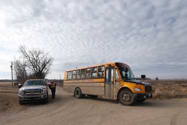 A bus load of searchers heads out past a checkpoint to look through farmers' field and ditches hoping to find 2 year old Chase Martens near Austin, Man., on Thursday, March 24, 2016. THE CANADIAN PRESS/John Woods