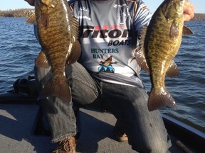 Local tournament angler, fishing guide and new Sudbury Star outdoors columnist Frank Clark shows off a pair of Ramsey Lake smallmouth bass from last spring.