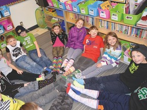 Skylar Fauser (top, second from right) and her classmates show off their colourful and patterned socks on Silly Socks Day. - Photo by Marcia Love