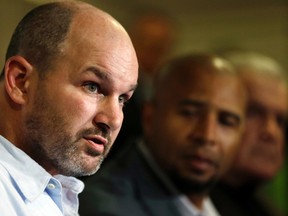 Former NFL player Kevin Turner, left, speaks as former players Dorsey Levens, center, and Bill Bergey listen during a a news conference in Philadelphia, after a hearing to determine whether the NFL faces years of litigation over concussion-related brain injuries. (AP Photo/Matt Rourke, File)