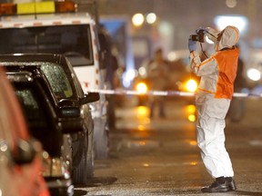 A Belgian forensic police takes pictures during police operations in Schaerbeek following Tuesday's bomb attacks in Brussels, Belgium. (REUTERS/Vincent Kessler)