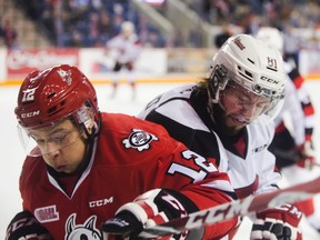 Stephen Harper of the Niagara IceDogs tangles with Nathan Todd of the 67’s during Game 1 of their playoff series. (Julie Jocsak, Postmedia Network)