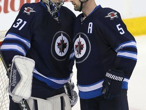 Ondrej Pavelec & Mark Stuart celebrate their win — for what it's worth. (BRIAN DONOGH/Winnipeg Sun)