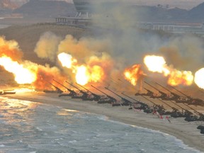 Artillery pieces are seen being fired during a military drill at an unknown location, in this undated photo released by North Korea's Korean Central News Agency (KCNA) on March 25, 2016. REUTERS/KCNA