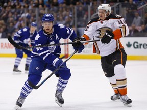 Ducks defenceman Josh Manson (right), seen here in action against Leafs forward Tyler Bozak on Thursday in Toronto, was fined by the NHL for a throat-slashing gesture on Friday, March 25, 2016. (Jack Boland/Toronto Sun/Postmedia Network)