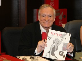 In this Nov. 15, 2007 photo, Hugh Hefner smiles while signing copies of the Playboy calendar and Playboy Cover To Cover: The 50's DVD box set in Los Angeles. (Ian West/PA via AP)