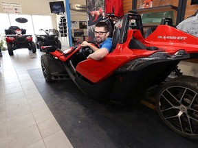 Tyler Bromley, sales manager at Rond's Marine, poses with the Polaris Slingshot in their Plessis Road showroom in Winnipeg on Thu., March 24, 2016. (Kevin King/Winnipeg Sun/Postmedia Network)